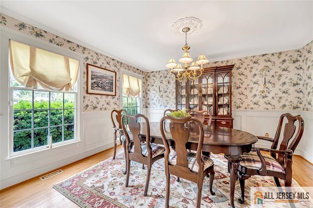 35 Parkview Rd, Cranbury, NJ 08512 - dining space with a chandelier, light wood-style flooring, wallpapered walls, ornamental molding, and a wainscoted wall