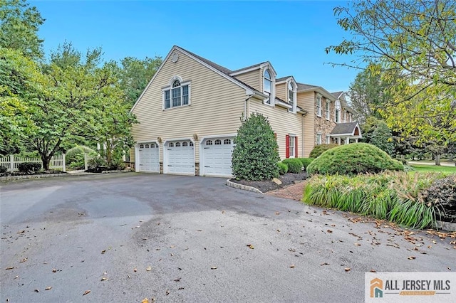 35 Parkview Rd, Cranbury, NJ 08512 - view of home's exterior featuring a garage and asphalt driveway