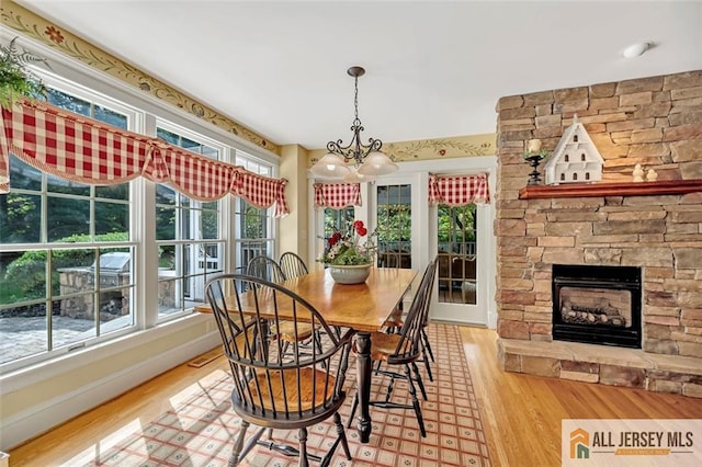 35 Parkview Rd, Cranbury, NJ 08512 - dining area featuring wood finished floors, a chandelier, and a fireplace