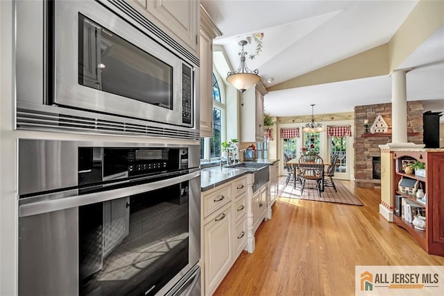 35 Parkview Rd, Cranbury, NJ 08512 - kitchen featuring stainless steel appliances, ornate columns, lofted ceiling, light wood-style flooring, and pendant lighting