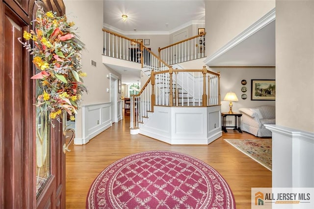 35 Parkview Rd, Cranbury, NJ 08512 - entrance foyer featuring wood finished floors, stairway, a wainscoted wall, ornamental molding, and a towering ceiling