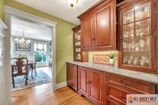 35 Parkview Rd, Cranbury, NJ 08512 - bar area featuring a chandelier, light wood finished floors, and decorative light fixtures