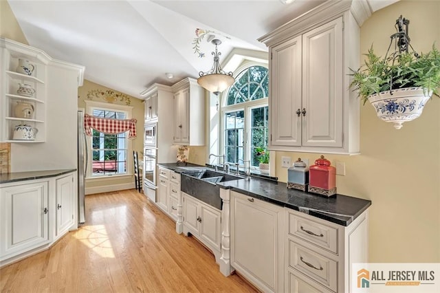 35 Parkview Rd, Cranbury, NJ 08512 - kitchen with vaulted ceiling, dark countertops, open shelves, light wood-style floors, and stainless steel appliances
