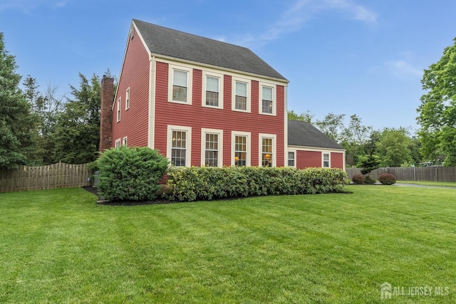 26 Magnolia Rd, Franklin Twsp, NJ 08873 - view of front facade with roof with shingles and a chimney