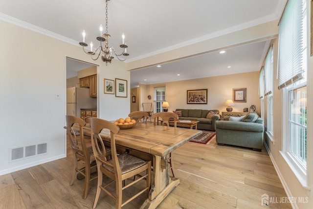 26 Magnolia Rd, Franklin Twsp, NJ 08873 - dining area featuring light wood-type flooring, a chandelier, crown molding, baseboards, and recessed lighting