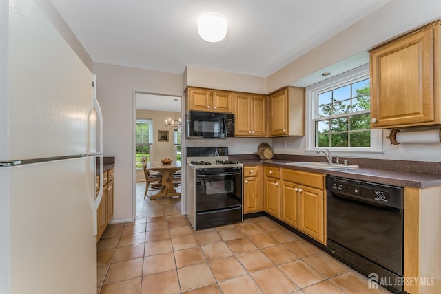 26 Magnolia Rd, Franklin Twsp, NJ 08873 - kitchen featuring black appliances, a sink, dark countertops, and plenty of natural light