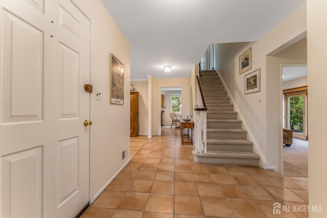 26 Magnolia Rd, Franklin Twsp, NJ 08873 - entrance foyer featuring stairway, healthy amount of natural light, baseboards, and light tile patterned floors