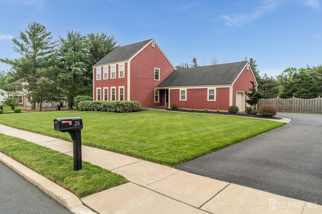26 Magnolia Rd, Franklin Twsp, NJ 08873 - colonial-style house featuring an attached garage, asphalt driveway, and a shingled roof