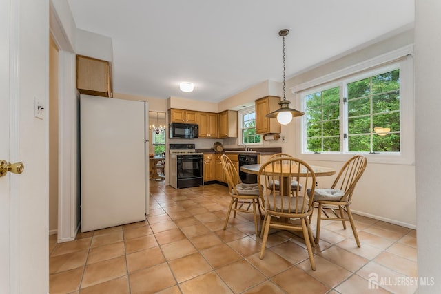 26 Magnolia Rd, Franklin Twsp, NJ 08873 - dining space featuring light tile patterned floors, a chandelier, and baseboards