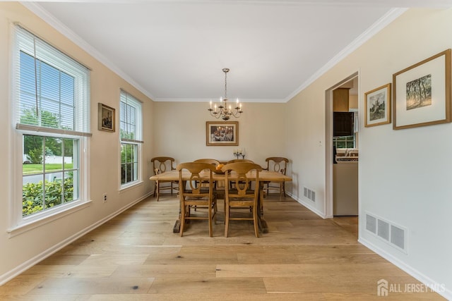 26 Magnolia Rd, Franklin Twsp, NJ 08873 - dining room with a chandelier, ornamental molding, light wood-type flooring, and baseboards