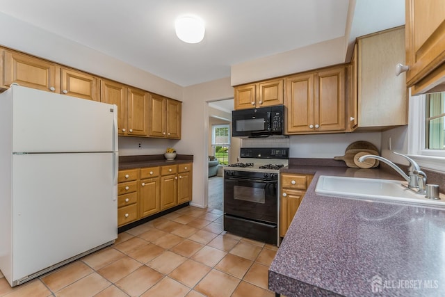 26 Magnolia Rd, Franklin Twsp, NJ 08873 - kitchen with freestanding refrigerator, gas range, black microwave, a sink, and dark countertops