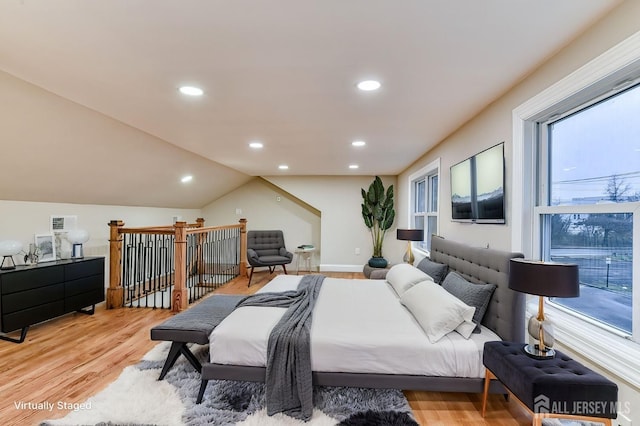 bedroom with vaulted ceiling, recessed lighting, visible vents, and light wood-style floors