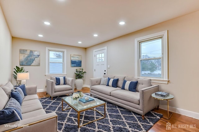 living room with recessed lighting, a healthy amount of sunlight, and wood finished floors