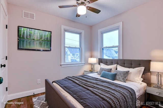 bedroom featuring ceiling fan, baseboards, visible vents, and dark wood finished floors