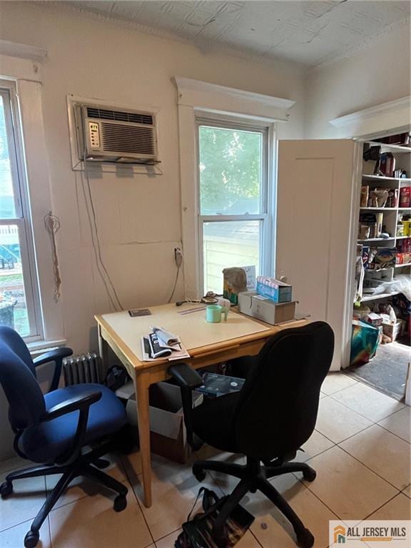 tiled office space with a wall unit AC and a wealth of natural light