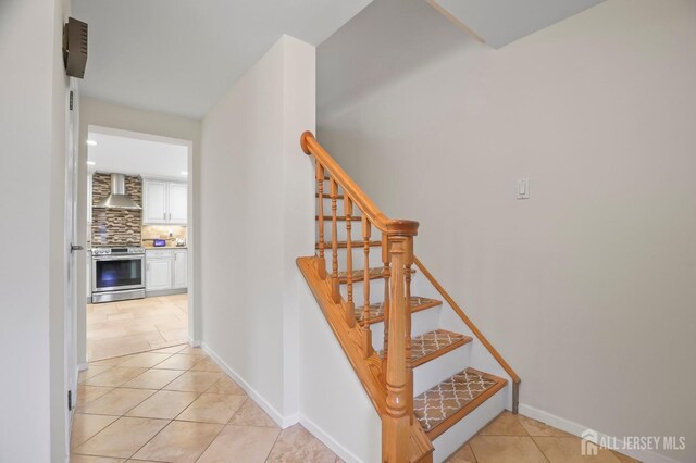 stairway featuring tile patterned flooring