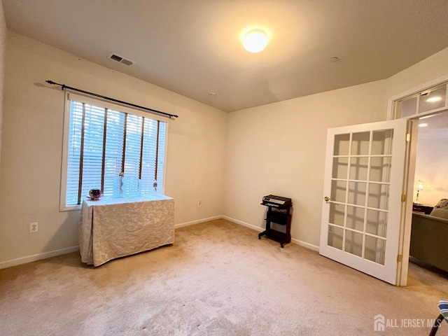 carpeted empty room with baseboards and visible vents