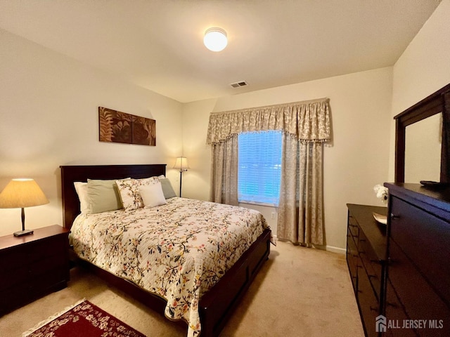 carpeted bedroom featuring visible vents and baseboards