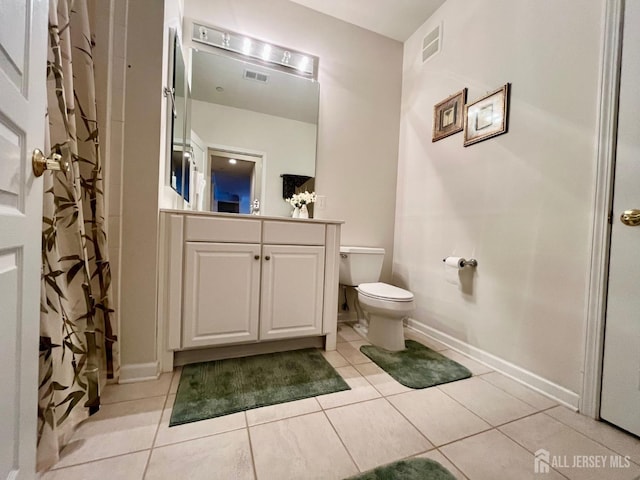 full bath with visible vents, tile patterned floors, baseboards, vanity, and toilet