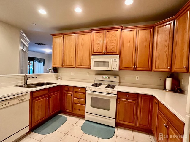 kitchen with white appliances, light tile patterned floors, recessed lighting, and a sink