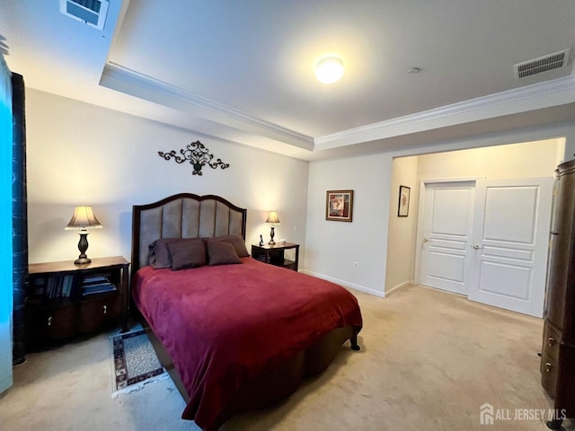 carpeted bedroom featuring visible vents, baseboards, crown molding, and a tray ceiling