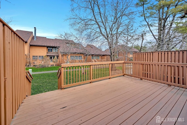 wooden deck with a lawn and a residential view