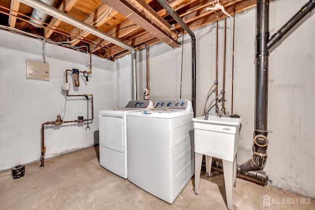 clothes washing area featuring washing machine and clothes dryer and laundry area