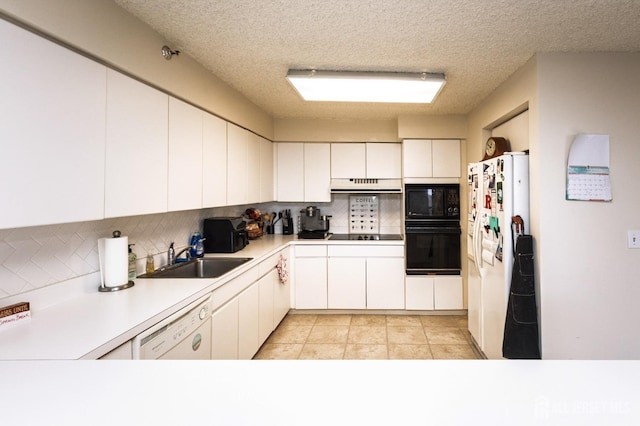 kitchen featuring a sink, black appliances, light countertops, and white cabinets