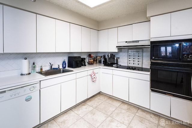 kitchen featuring white cabinets, a sink, under cabinet range hood, and black appliances