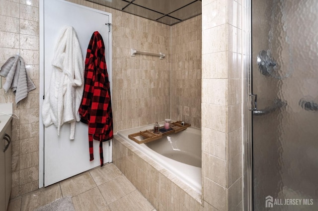 bathroom with a stall shower and a bath