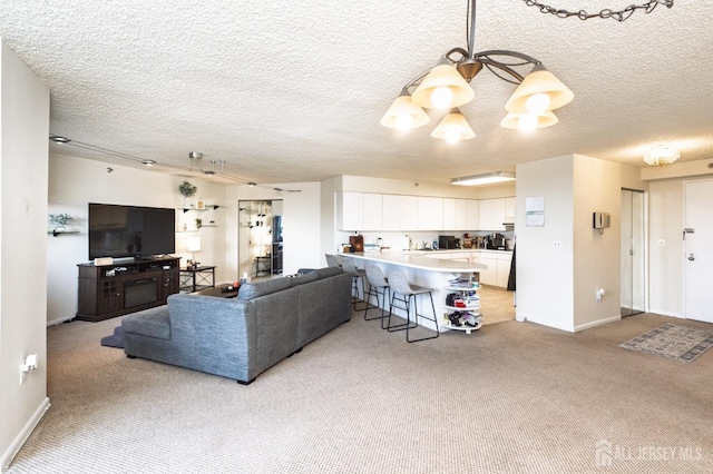 living room featuring light carpet, an inviting chandelier, baseboards, and a textured ceiling