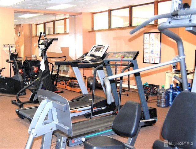 exercise room featuring a paneled ceiling