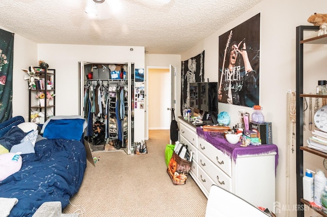 carpeted bedroom with a textured ceiling and a closet