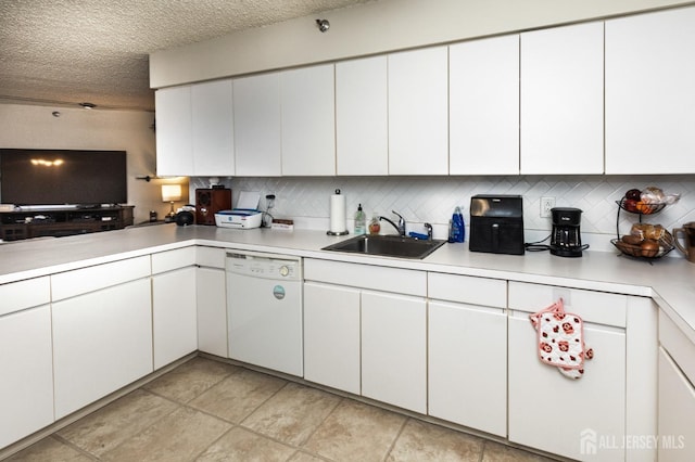 kitchen with light countertops, a sink, and dishwasher