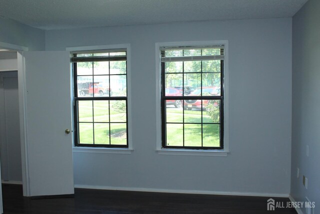 29 E Wycoff Way E, Brunswick, NJ 08816 - empty room with dark wood-style floors and baseboards