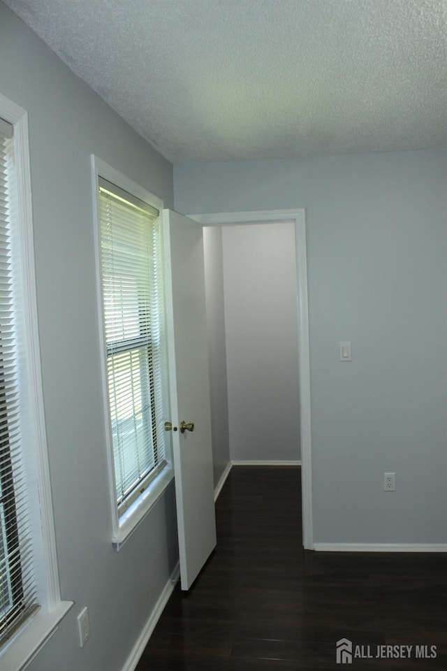 29 E Wycoff Way E, Brunswick, NJ 08816 - hall featuring a textured ceiling and dark wood-type flooring