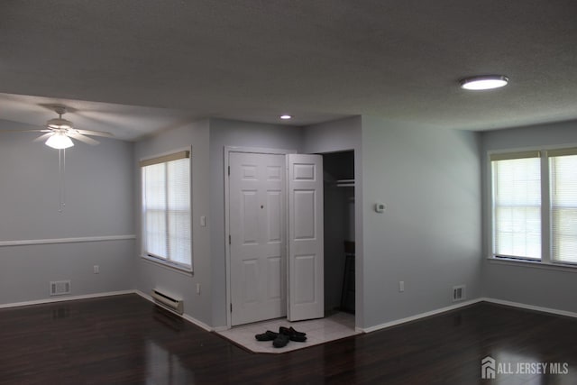 29 E Wycoff Way E, Brunswick, NJ 08816 - entryway with wood finished floors, ceiling fan, and a baseboard radiator