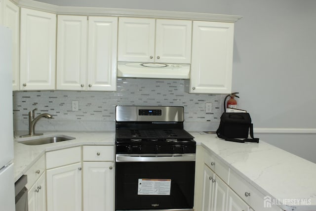 29 E Wycoff Way E, Brunswick, NJ 08816 - kitchen featuring stainless steel gas range oven, under cabinet range hood, decorative backsplash, and white cabinetry