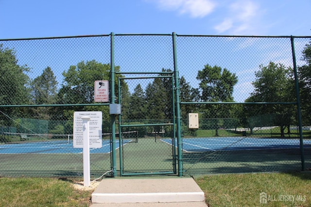 29 E Wycoff Way E, Brunswick, NJ 08816 - view of tennis court with a gate