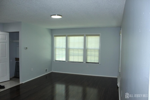 29 E Wycoff Way E, Brunswick, NJ 08816 - unfurnished bedroom featuring a textured ceiling, wood finished floors, and a closet