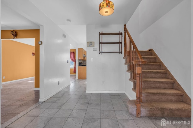 staircase with tile patterned floors