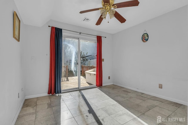 tiled spare room with ceiling fan