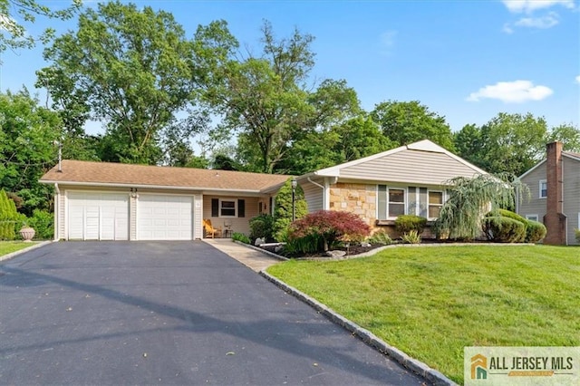 23 Spring St, Franklin, NJ 08873 - view of front facade with asphalt driveway, a garage, a front yard, and stone siding