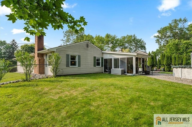 23 Spring St, Franklin, NJ 08873 - rear view of property featuring a chimney and a sunroom