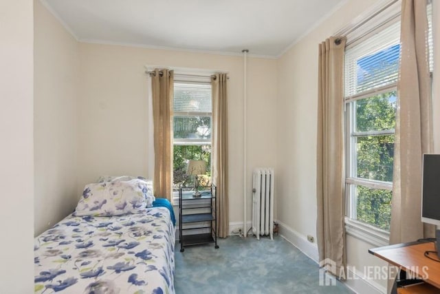 carpeted bedroom featuring baseboards, crown molding, and radiator heating unit