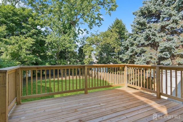 wooden terrace with a lawn