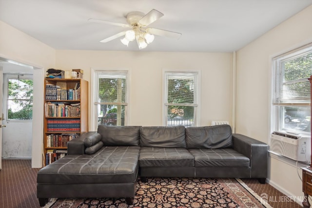 living room featuring carpet, cooling unit, a ceiling fan, and baseboards