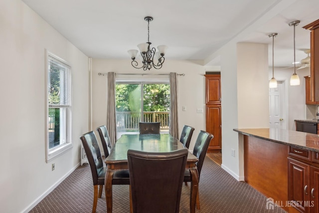 dining area with baseboards, dark carpet, and an inviting chandelier