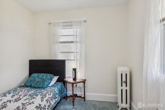 bedroom with radiator heating unit and baseboards