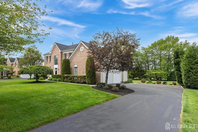 24 Saddle Ct, Monroe, NJ 08831 - view of side of home featuring driveway, brick siding, a garage, and a yard